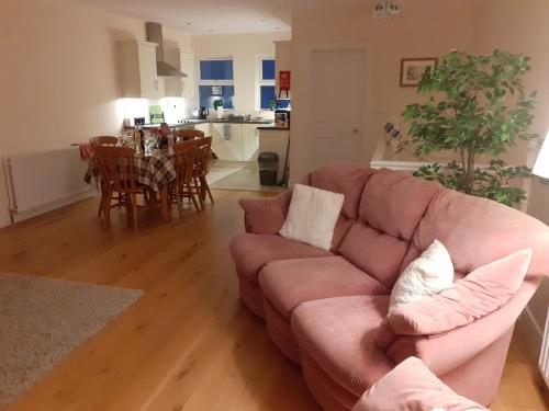 a living room with a couch and a dining room at Beachside Holiday Home in Portrush