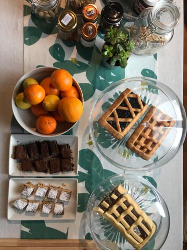 a table topped with plates of food and waffles and fruit at INVENTO bnb unconventional maison in Civitanova Marche