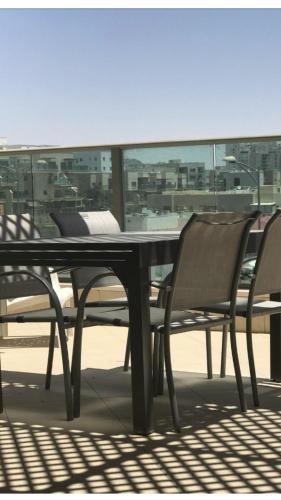 a table and chairs with a view of a city at CHAMBRES D’HÔTES EILAT in Eilat