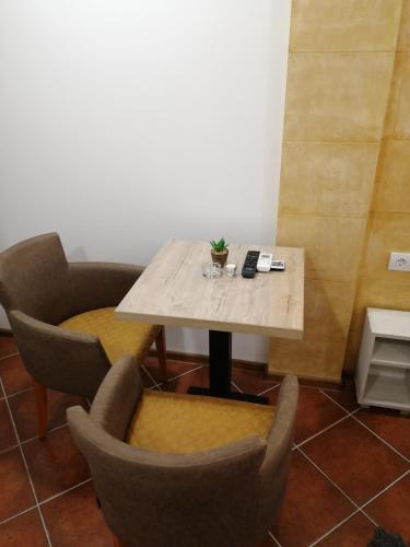 a table and chairs in a room at Vila Violeta in Šabac