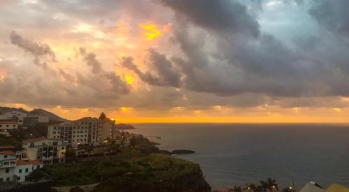 a view of the ocean with a cloudy sky at Sol & Mar Camara de Lobos in Câmara de Lobos