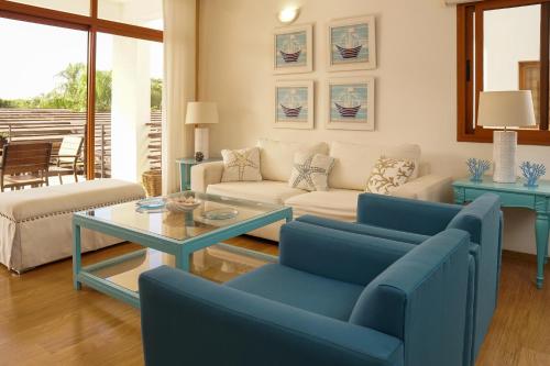 a living room with a couch and a table at Sybaris Suites & Residences in Juan Dolio