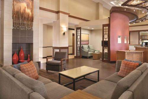 a lobby with a couch and a table and chairs at Hyatt Place Chicago Hoffman Estates in Hoffman Estates