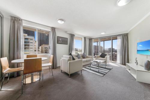 a living room with a couch and a table at The Capitol Apartments in Brisbane