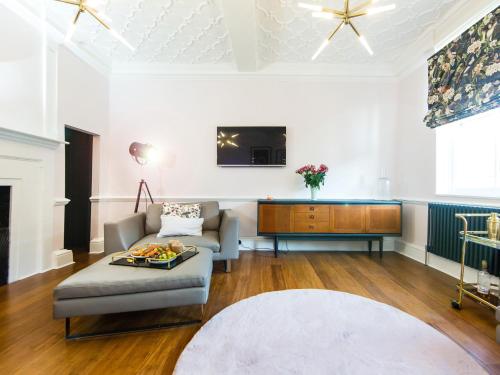 a living room with a couch and a tv at Luxury Travel Emporium YO1 - Exquisite 400 Year Old, City Centre Townhouse in York