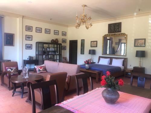a living room with a couch and a bed and a table at Ivory Falls Villa in Di Linh