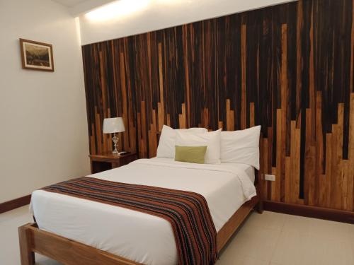 Een bed of bedden in een kamer bij San Pedro Country Farm Resort and Event Center Inc