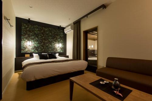 a bedroom with a bed and a couch at Tsuki no Yado Kaguya in Kawagoe