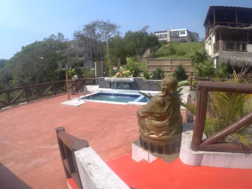 a statue of a mermaid sitting on a patio at The Heights in Montañita in Montañita