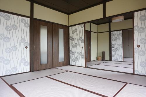 a drawing of a room with doors and walls at Tsubaki House in Anan