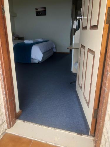 
a bedroom with a bed and a door at Stansbury Holiday Motel in Stansbury
