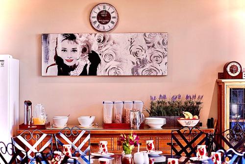 a clock on a wall above a table with dishes at Kurrajong House in Launceston