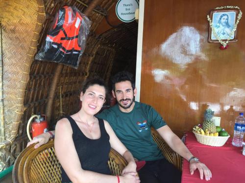a man and a woman posing for a picture at Thara's Houseboat in Alleppey