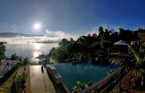 a large swimming pool with a view of a river at THE NIHAL RESORT in Mahabaleshwar