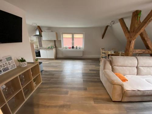 a living room with a couch and a television at StorchenHof in Schmogrow