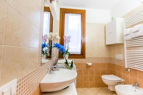 a bathroom with a sink and toilet and a window at Agriturismo Ca' Baccan in Cavallino-Treporti
