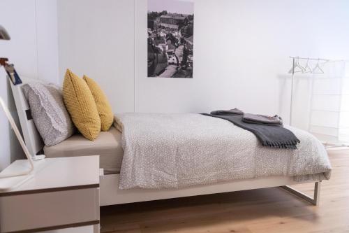 a bedroom with a bed and a picture on the wall at Park City Center in Luxembourg