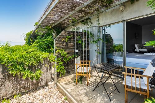 a room with a table and a chair on a balcony at Mazagonia in Mazagón