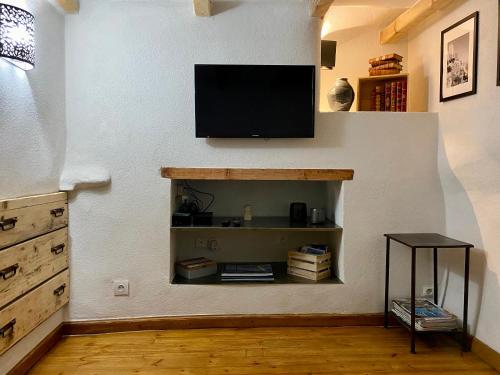 a living room with a flat screen tv on a wall at Charmant studio vieil Antibes in Antibes