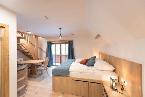 a bedroom with a bed and a desk and a table at Guesthouse Lajnar in Zgornja Sorica