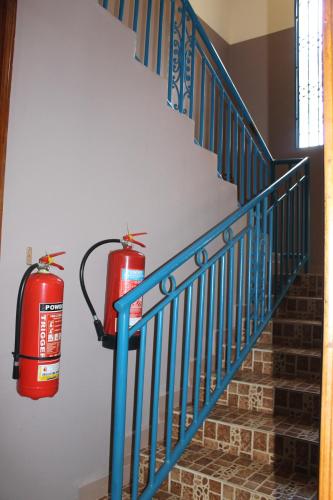 two fire hydrants on the wall next to a staircase at Namulanda Motel in Entebbe
