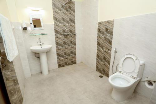 a bathroom with a toilet and a sink at Pokhara Backpackers Hostel in Pokhara