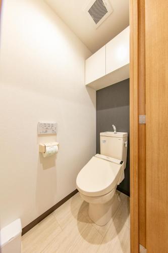 a bathroom with a white toilet in a room at Lespedeza Osaka in Osaka