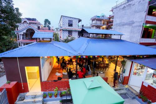 an overhead view of a restaurant with a blue roof at Pokhara Backpackers Hostel in Pokhara