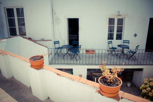 a balcony with chairs and tables on a patio at Hostel Portalegre in Portalegre