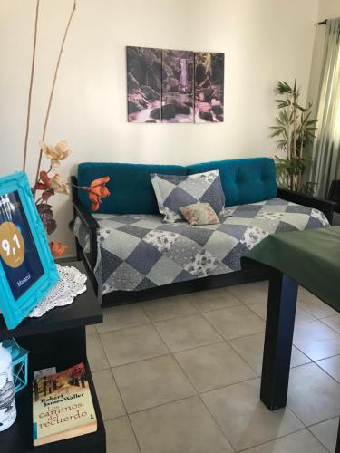 sala de estar con sofá azul y mesa en marazul en San Antonio de Padua
