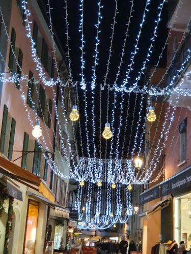 a street with christmas lights hanging from the ceiling at Le Merle Châtelain in Sion
