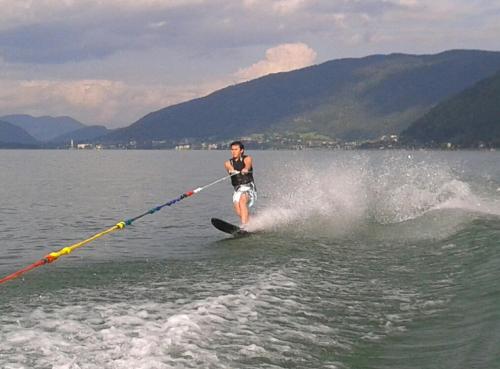 a person water skiing on the water with a rope at Ferienhaus Burgblick in Treffen