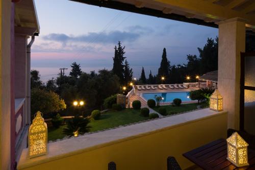 a view from the balcony of a house with a pool at Niki Sunrise Apartments in Gastourion
