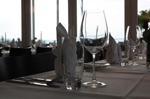 a table with three wine glasses on a table at Gasthof Seefeld in Hurden