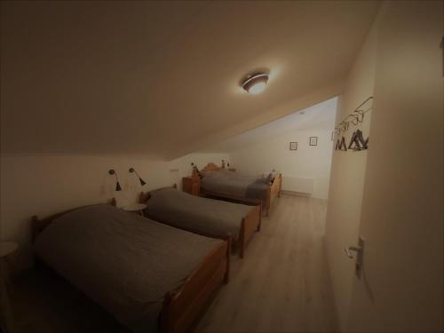 a room with three beds and a hallway at De Hammerhoeve in Dalfsen