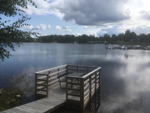 a dock on a lake with boats in the water at Fegens Vandrarhem in Fegen