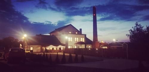 a house with a chimney and a building with a pole at Zajazd Bog-Mar in Rymanów