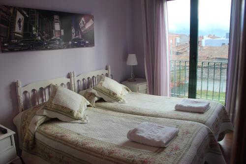 Postel nebo postele na pokoji v ubytování Hostal Maury