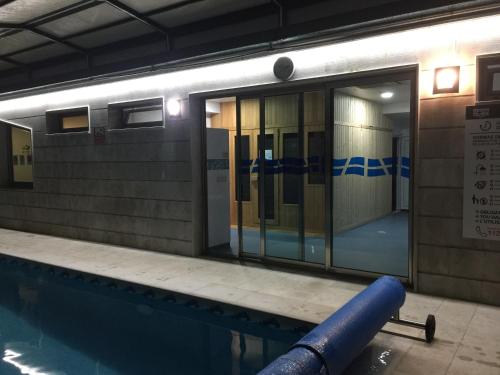 a swimming pool with a door in a building at Hotel San Millán in Santander