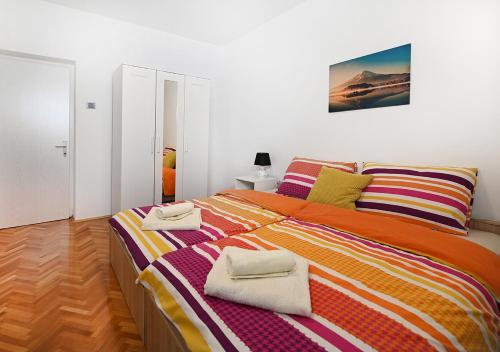 a bedroom with a large bed with towels on it at Zagreb Apartmani Santana in Zagreb