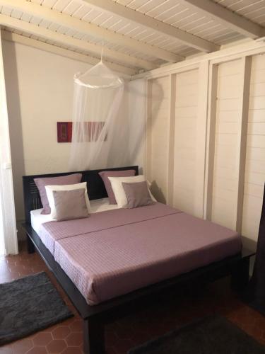 a large bed in a room with at Villa Les Trois Moulins in Saint-François