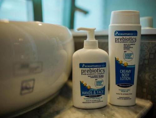 two bottles of cleaning products sitting next to a sink at Dalat Terrasse Des Roses Villa in Da Lat