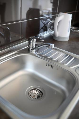 a kitchen sink with a faucet on a counter at Apartments Noa Nin Ždrijac in Nin