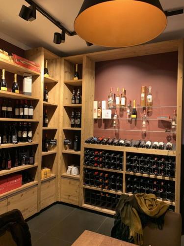 a wine tasting room with a bunch of wine bottles at Hotel Maxdorfer Hof in Maxdorf