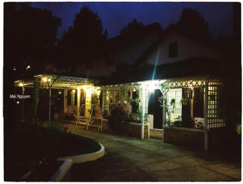 a house with lights on the front of it at night at Dalat Terrasse Des Roses Villa in Da Lat