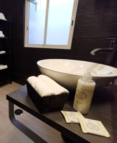 a bathroom with a white tub and a sink at Downtown Loulé in Loulé
