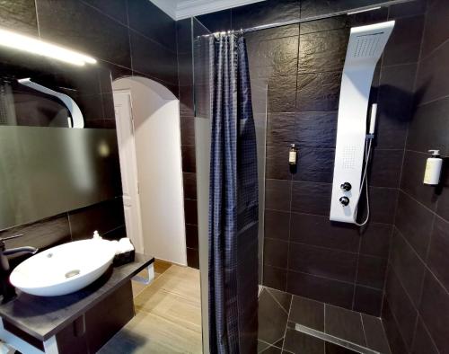 a bathroom with a sink and a shower at Downtown Loulé in Loulé