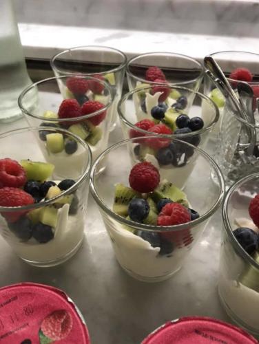 four bowls filled with fruit and yogurt on a table at Boutique Hotel Huys van Steyns in Tongeren