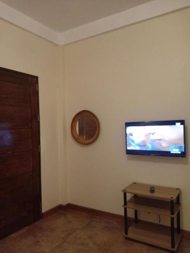 a living room with a flat screen tv on a wall at Villa Skanderbeg Guest House in Puerto Princesa City