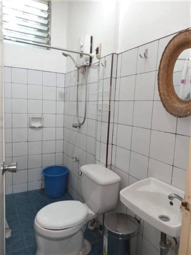 a white bathroom with a toilet and a sink at Felipa Beach Residence - Jasmine in Dumaguete